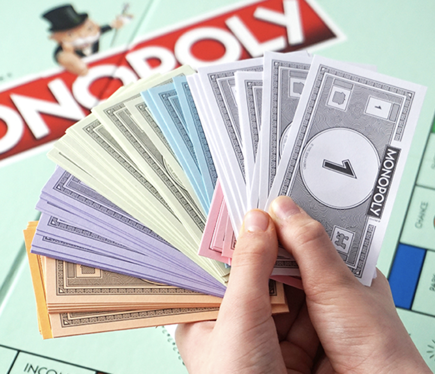 Hand holding Monopoly money